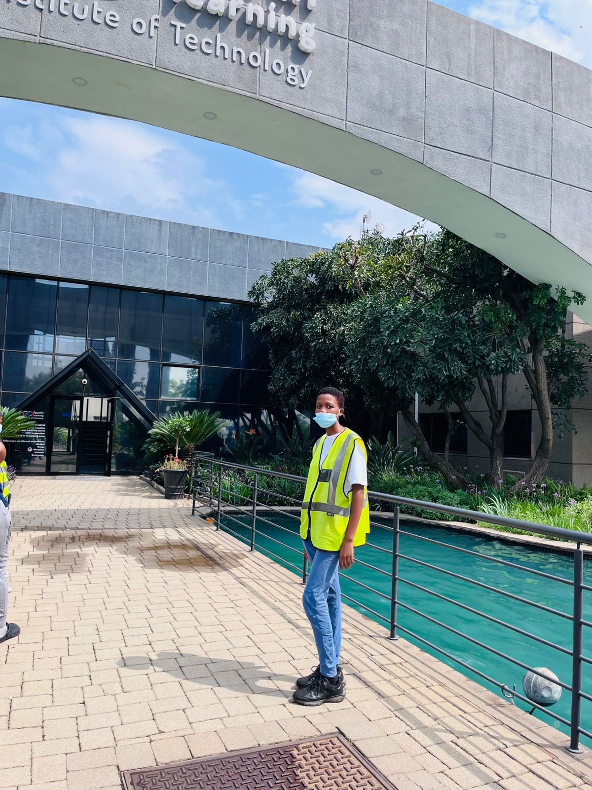 Worker standing outdoors on a paved walkway